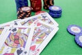 Stack of poker chips and cards on a green game table Royalty Free Stock Photo